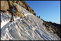 Hikers traversing a steep snowfield below Forester Pass, Kings Canyon National Park. California ( color)