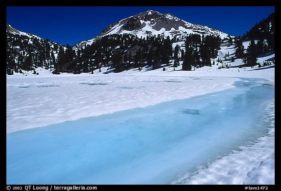 Turquoise melting snow in lake Helen and Lassen Peak, late spring. Lassen Volcanic National Park, California, USA.