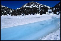 Turquoise melting snow in lake Helen and Lassen Peak, late spring. Lassen Volcanic National Park, California, USA.