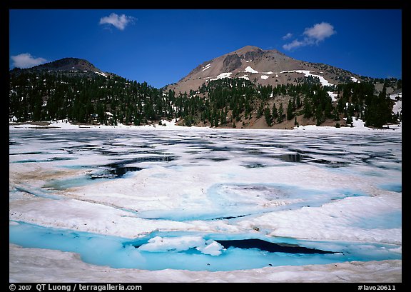 Helen Lake with Ice breaking up, and Lassen Peak. Lassen Volcanic National Park, California, USA.