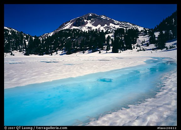 Turquoise melting snow in lake Helen and Lassen Peak, late spring. Lassen Volcanic National Park, California, USA.