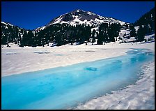 Turquoise melting snow in lake Helen and Lassen Peak, late spring. Lassen Volcanic National Park, California, USA.
