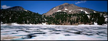 Melting ice in lake and Lassen Peak. Lassen Volcanic National Park, California, USA.