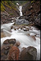 Water flowing over boulders from waterfall. Mount Rainier National Park, Washington, USA.