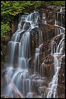 Water cascading over columns of volcanic rock. Mount Rainier National Park, Washington, USA.