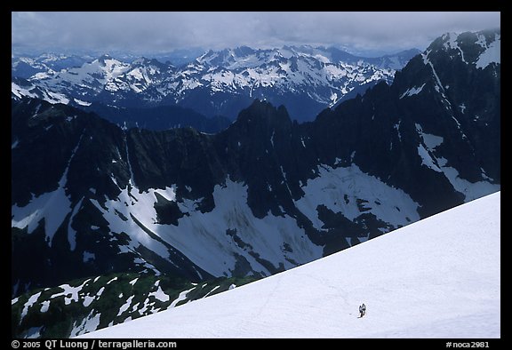 Mountain ridges, and mountaineers on snow field, North Cascades National Park. Washington, USA.