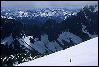 Mountain ridges, and mountaineers on snow field, North Cascades National Park. Washington, USA.