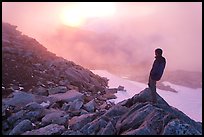 Visitor on ridge waches foggy sunset, North Cascades National Park.  ( color)