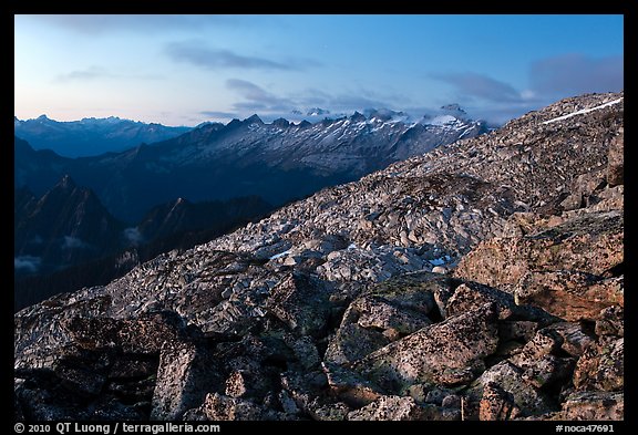 Rocky slope and distant range at dusk, North Cascades National Park. Washington, USA.