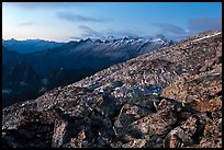 Rocky slope and distant range at dusk, North Cascades National Park. Washington, USA.