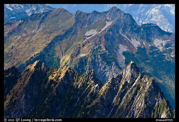 Steep forested spires in dabbled light, North Cascades National Park. Washington, USA.