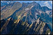 Steep forested spires in dabbled light, North Cascades National Park. Washington, USA.