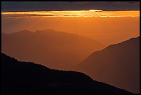 Layered ridges with sun behind clouds, North Cascades National Park. Washington, USA.