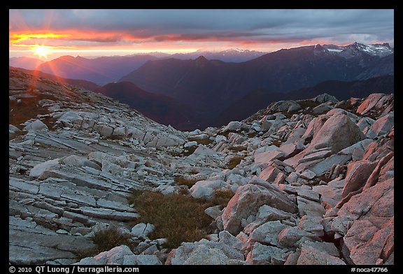 Last rays of sunset color rocks in alpine basin, North Cascades National Park. Washington, USA.