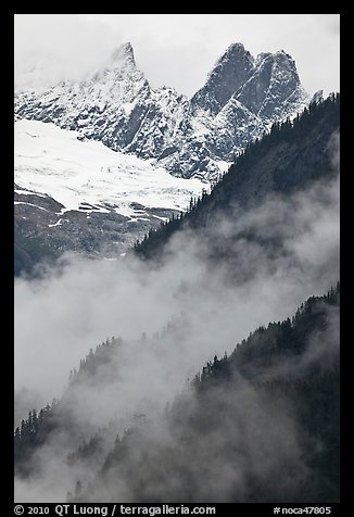 Inspiration Peak and the Pyramid rising above clouds, North Cascades National Park. Washington, USA.