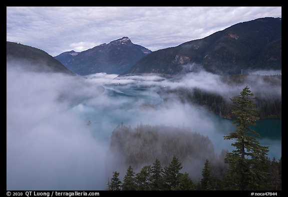 Low fog rolling over Diablo Lake, dawn, North Cascades National Park Service Complex. Washington, USA.