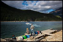 Guests waiting for ride across lake to Ross Lake resort, North Cascades National Park Service Complex. Washington, USA.