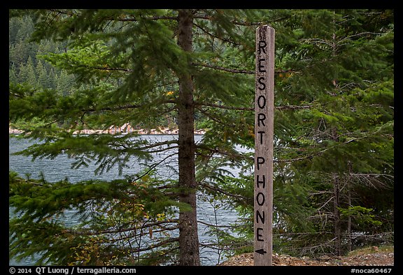 Sign pointing to phone used to call Ross Lake resort, North Cascades National Park Service Complex. Washington, USA.