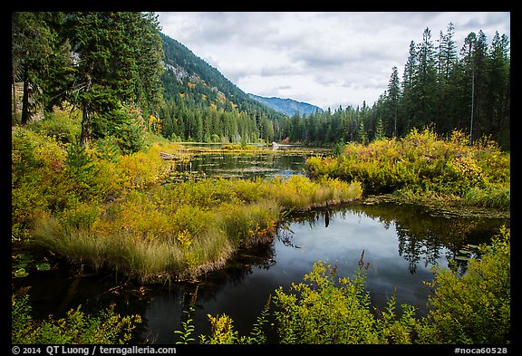 Mountains reflected in Coon Lake in the fall, North Cascades National Park Service Complex.  (color)