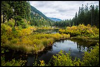 Mountains reflected in Coon Lake in the fall, North Cascades National Park Service Complex. Washington, USA.