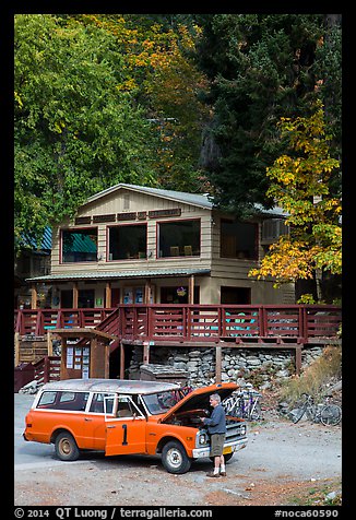 Man fixing old car in front of North Cascades Lodge, Stehekin, North Cascades National Park Service Complex.  (color)