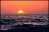 Disc of sun setting in  pacific, Shi-shi beach. Olympic National Park, Washington, USA.