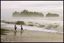 Children running along surf, Rialto Beach. Olympic National Park, Washington, USA.