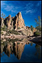 Climber standing on spire next to Bear Gulch Reservoir. Pinnacles National Park ( color)