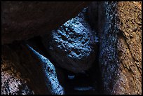 Dark passage with wedged boulder, Balconies Cave. Pinnacles National Park, California, USA.