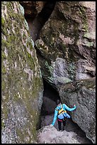 Woman walking into Balconies Cave. Pinnacles National Park, California, USA. (color)
