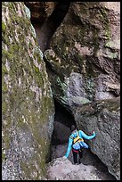 Woman walking into Balconies Cave. Pinnacles National Park ( color)