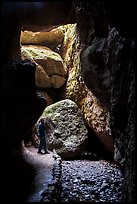 Hiker looking around Bear Gulch Cave. Pinnacles National Park ( color)