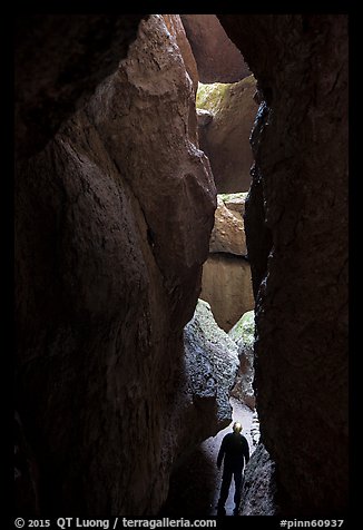 Hiker in narrow and deep section of Lower Bear Gulch Cave. Pinnacles National Park (color)