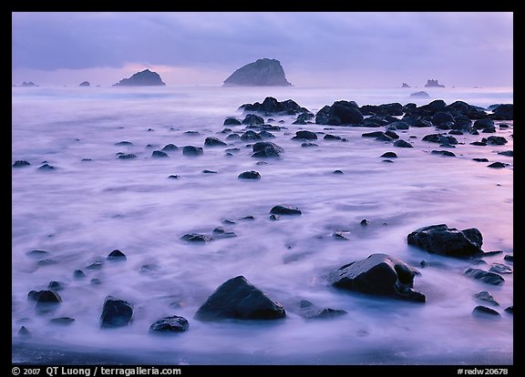 Wave motion over rocks in  purple light of dusk. Redwood National Park, California, USA.