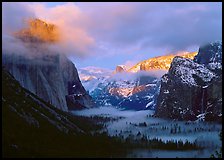 View with fog in valley and peaks lighted by sunset, winter. Yosemite National Park, California, USA.