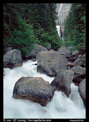 Boulders in frosty Merced River and distant Vernal Fall. Yosemite National Park, California, USA.