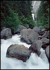 Boulders in frosty Merced River and distant Vernal Fall. Yosemite National Park, California, USA.