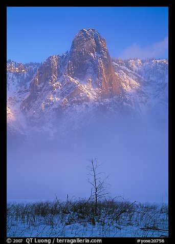 Sentinel rock rising above fog on valley in winter. Yosemite National Park, California, USA.