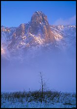 Sentinel rock rising above fog on valley in winter. Yosemite National Park, California, USA.