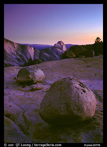 Glacial erratic boulders and Half Dome, Olmsted Point, dusk. Yosemite National Park, California, USA.