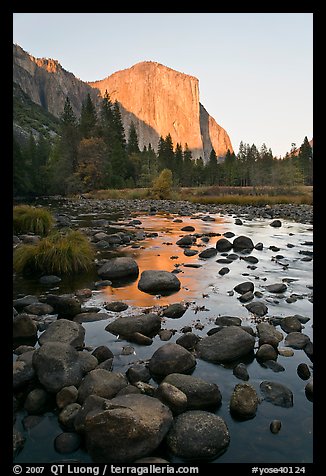 Boulders in Merced River and El Capitan at sunset. Yosemite National Park, California, USA.