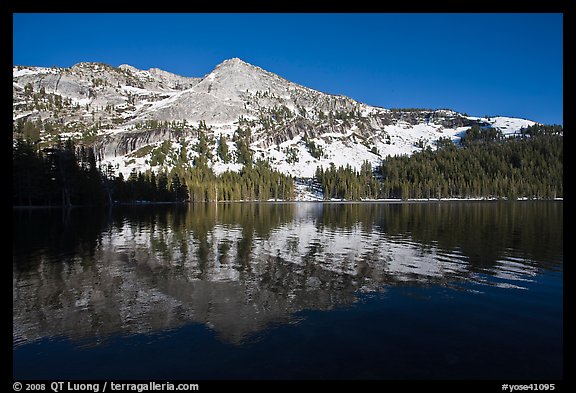 Tenaya Lake, with partly snow-covered peak reflected. Yosemite National Park, California, USA.