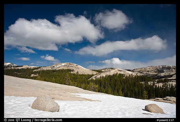 Snow on slab, boulders, and distant domes, Tuolumne Meadows. Yosemite National Park, California, USA.