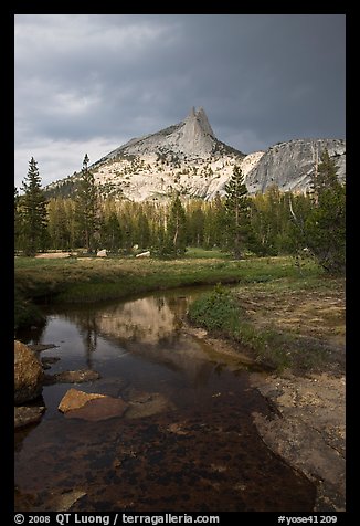 Cathedral Peak reflected in stream under stormy skies. Yosemite National Park, California, USA.