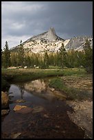 Cathedral Peak reflected in stream under stormy skies. Yosemite National Park, California, USA. (color)