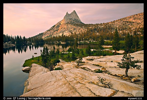 Granite slab, Upper Cathedral Lake, and Cathedral Peak, sunset. Yosemite National Park, California, USA.