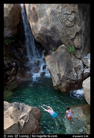 Swimmers in a pool at the base of Wapama falls, Hetch Hetchy. Yosemite National Park, California, USA.