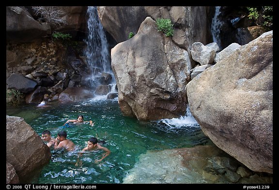 Children swimming in pool at the base of Wapama falls. Yosemite National Park, California, USA.