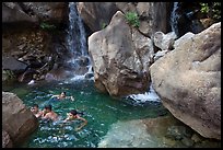 Children swimming in pool at the base of Wapama falls. Yosemite National Park, California, USA. (color)