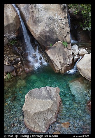 Boulder and emerald waters in pool, Wapama Falls, Hetch Hetchy. Yosemite National Park, California, USA.